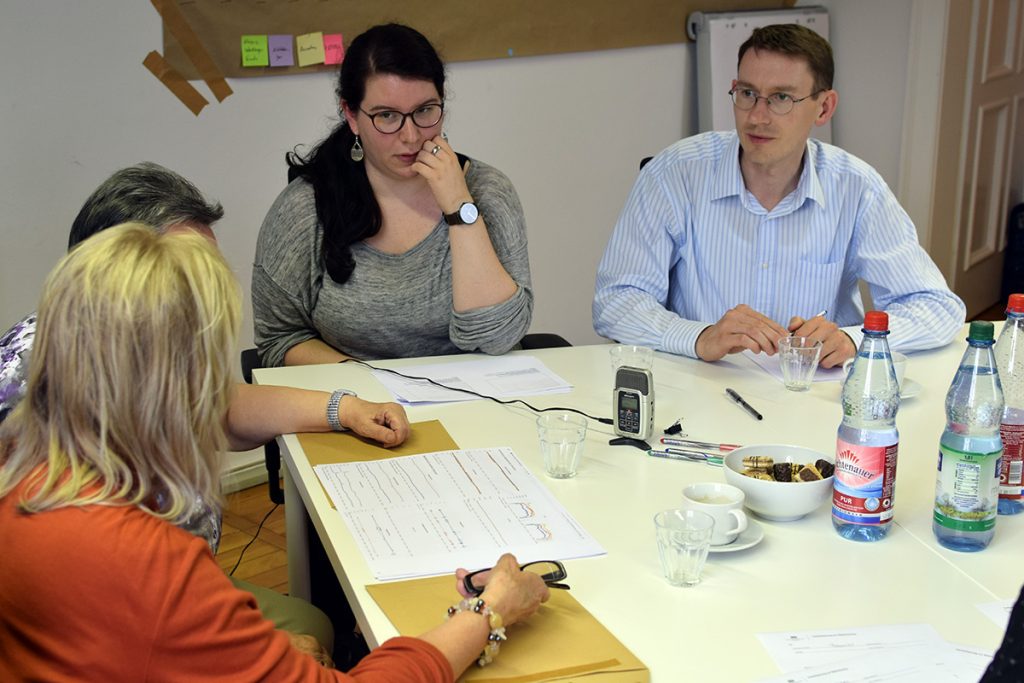 Four participants of a group discussion around sensor reading print outs