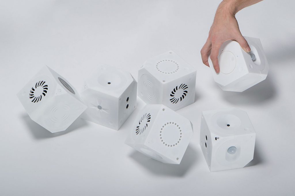 Three pairs of Loaded Dice on a plain surface, with one hand rolling of the cubes