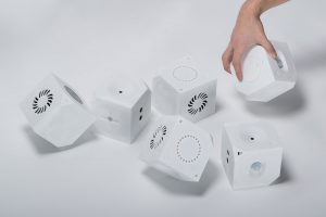 Three pairs of Loaded Dice on a plain surface, with one hand rolling of the cubes