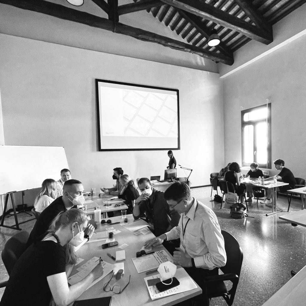 Black and White Image of a conference workshop in Venice at ACM Creativity and Cognition where about fifteen researchers try out co-design workshop methods
